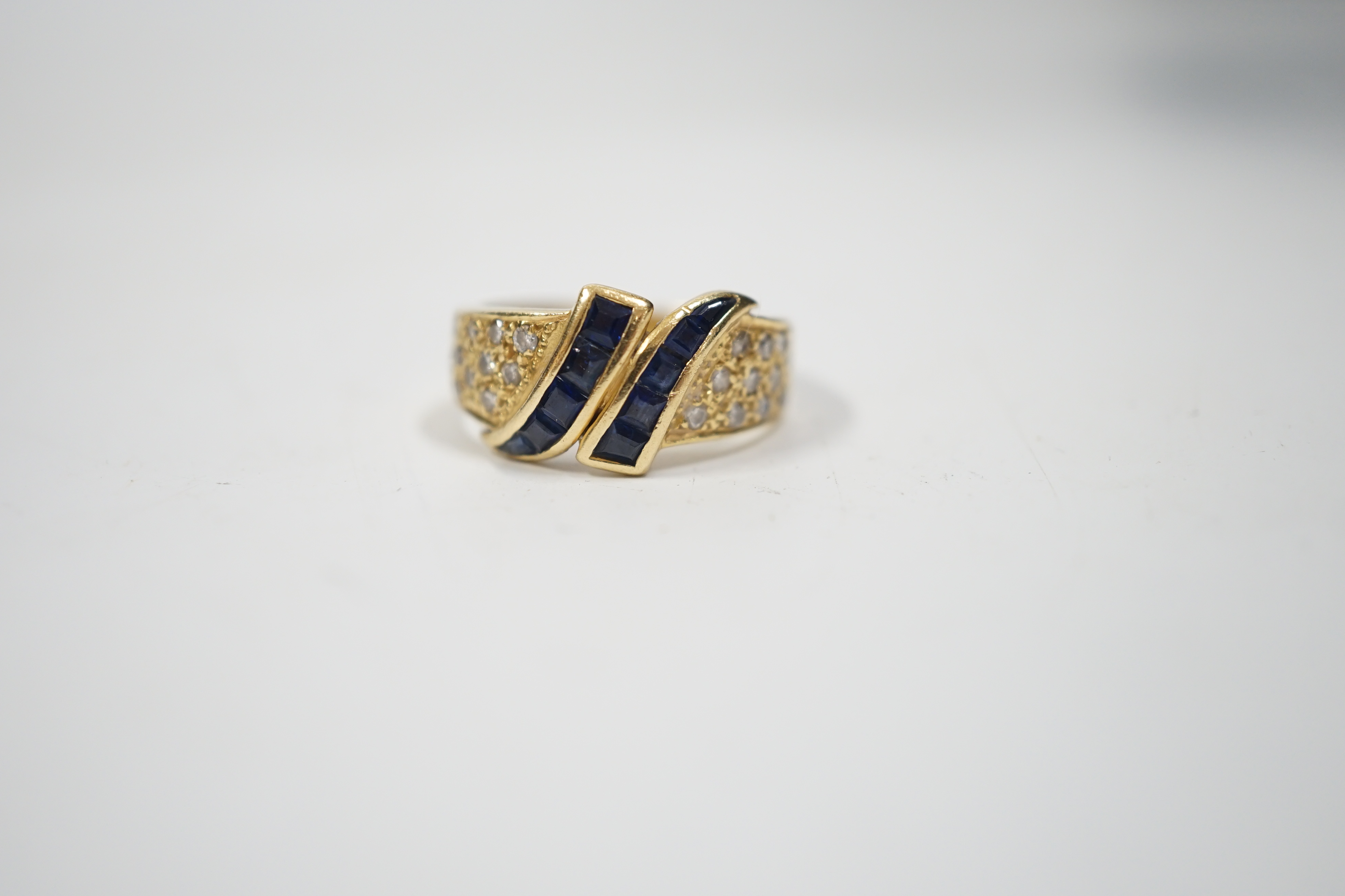 A modern 750 yellow metal, sapphire and diamond chip set dress ring, size K, gross weight 4.8 grams.